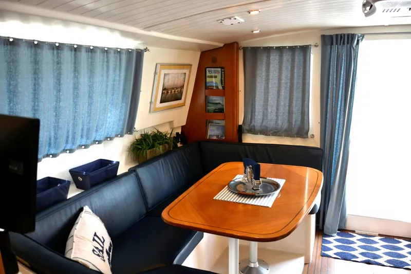 Slide: The Image of Interior of 2000 Fountaine Pajot Maryland 37 yacht with cozy seating and dining area. - 35