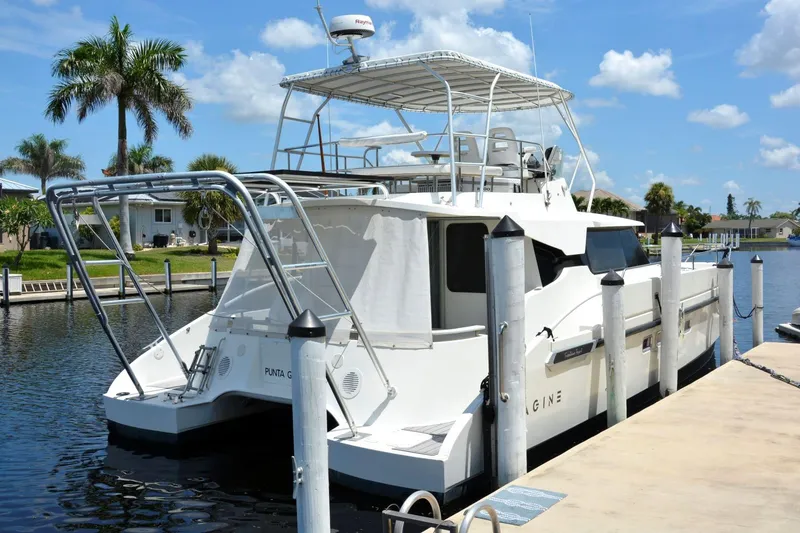 Slide: The Image of Fountaine Pajot Maryland 37 yacht docked, 2000 model, sunny day, palm trees in background. - 4
