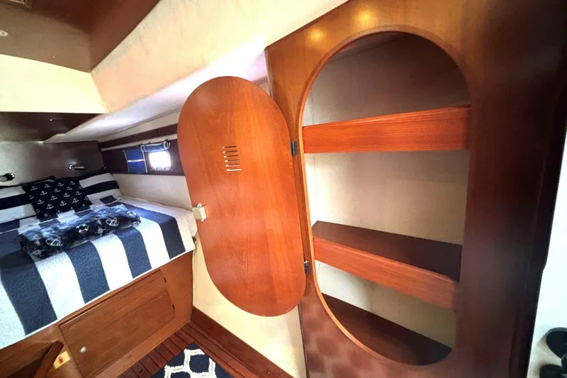 Slide: The Image of Cozy cabin interior of 2000 Fountaine Pajot Maryland 37 with wooden shelves and bed. - 62