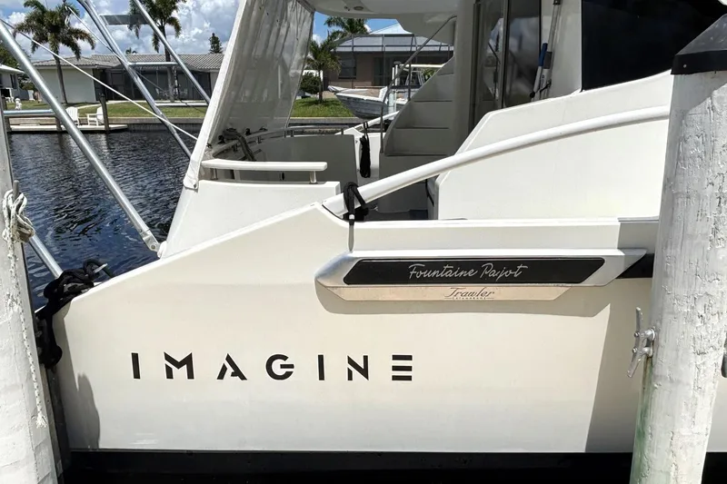 Slide: The Image of 2000 Fountaine Pajot Maryland 37 yacht docked, featuring "Imagine" on the side. - 7
