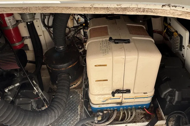 Slide: The Image of Engine compartment of a 2000 Fountaine Pajot Maryland 37, showing mechanical components and wiring. - 74