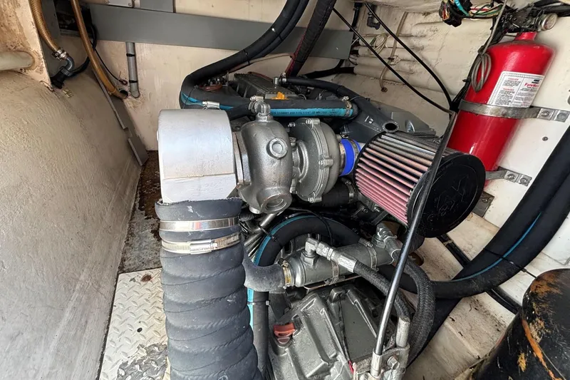 Slide: The Image of Engine room of 2000 Fountaine Pajot Maryland 37 with visible components and fire extinguisher. - 75