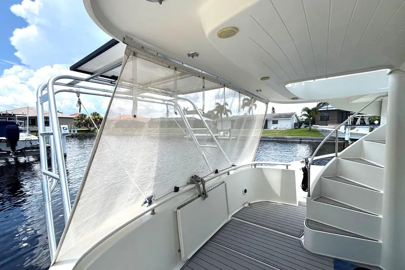 Slide: The Image of Fountaine Pajot Maryland 37 yacht deck with stairs, docked by waterfront homes, 2000 model. - 8