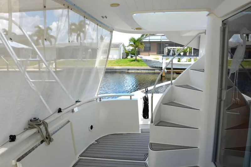 Slide: The Image of 2000 Fountaine Pajot Maryland 37 yacht interior with spiral staircase and waterfront view. - 9