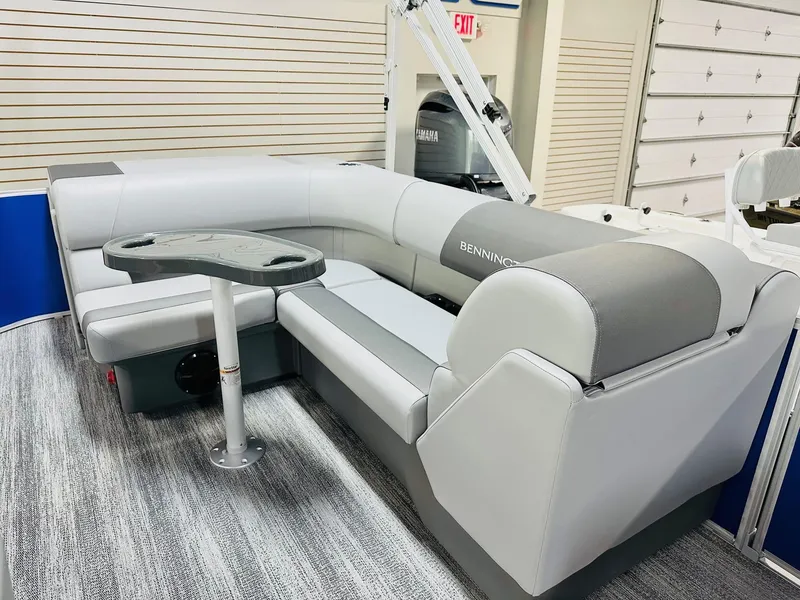 Slide: The Image of 2025 Bennington 21 SL pontoon boat interior with gray seating and table. - 4