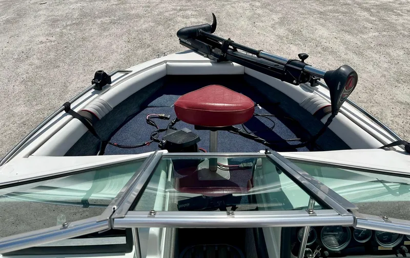 Slide: The Image of 1993 Sea Ray 170 BRLTD boat interior with red seat and trolling motor. - 4