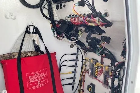 Slide: The Image of Storage area on a 2025 Custom Carolina Forbes boat with fishing gear and safety equipment. - 14