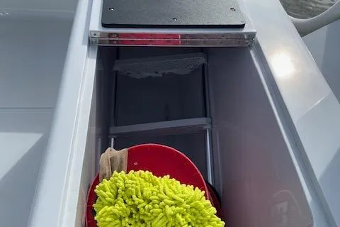 Slide: The Image of 2025 Custom Carolina Forbes boat with outboard motor docked at a marina. - 19