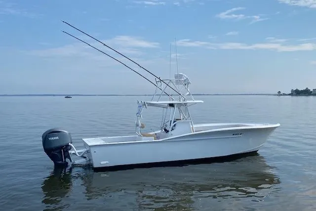 Slide: The Image of Steering wheel view on 2025 Custom Carolina Forbes boat, Garmin navigation, calm waters. - 22
