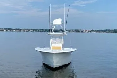 Slide: The Image of Custom Carolina Forbes 2025 boat on calm water under a clear sky. - 26