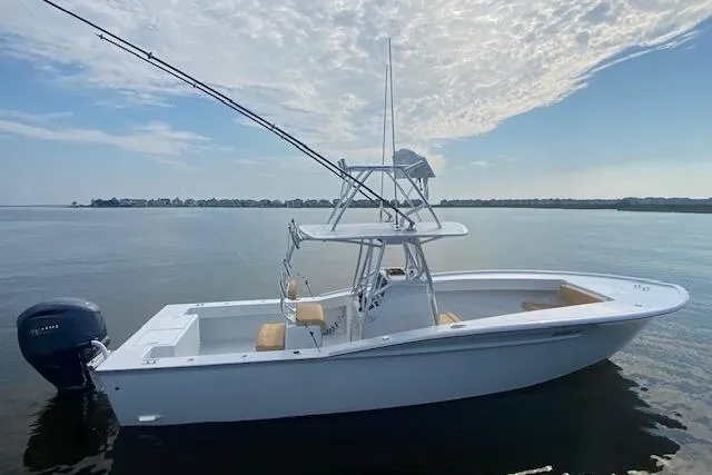 Slide: The Image of Custom Carolina Forbes 2025 boat on calm water with clear sky background. - 3