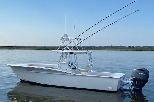 Slide: The Image of 2025 Custom Carolina Forbes boat on calm water under a partly cloudy sky. - 4