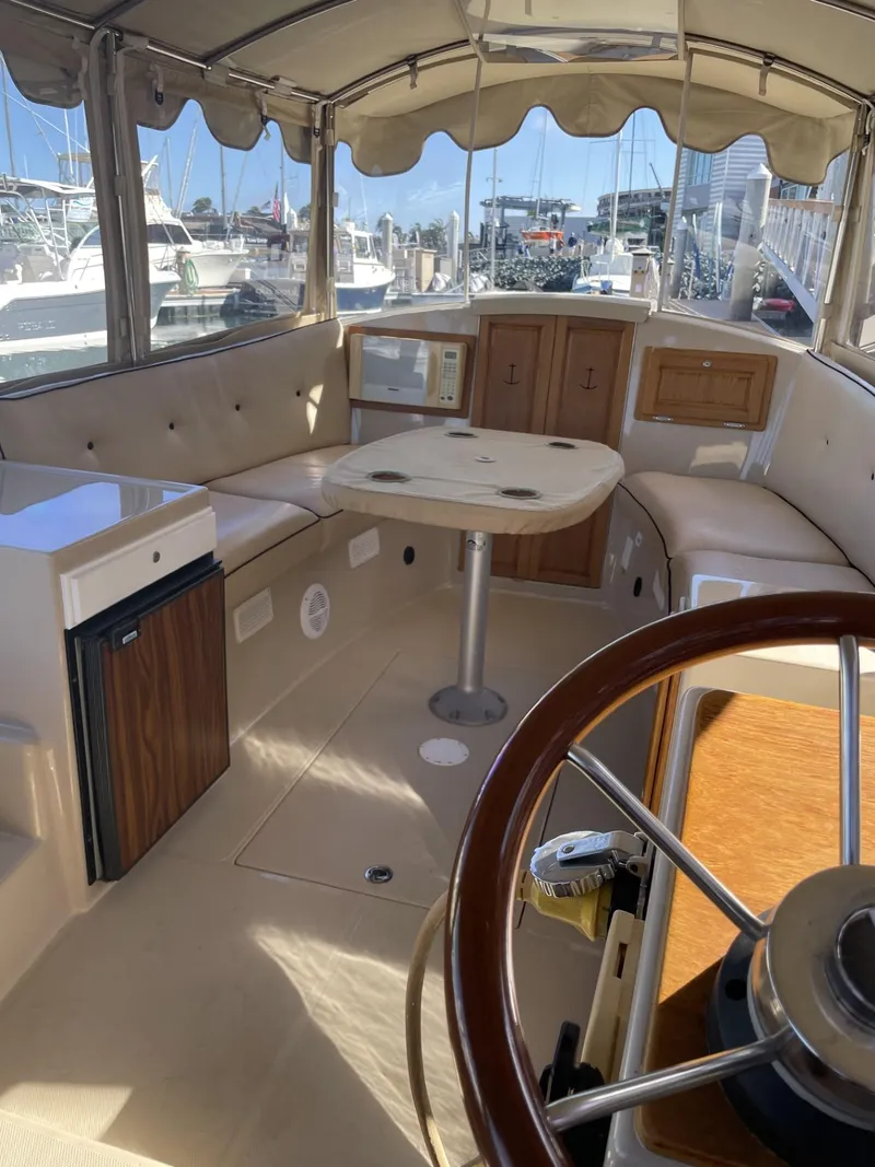 Slide: The Image of Interior of 2008 Duffy Cuddy 22 boat with seating, table, and steering wheel. - 10