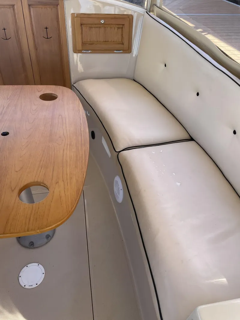 Slide: The Image of Interior of 2008 Duffy Cuddy 22 boat with cushioned seating and wooden table. - 4