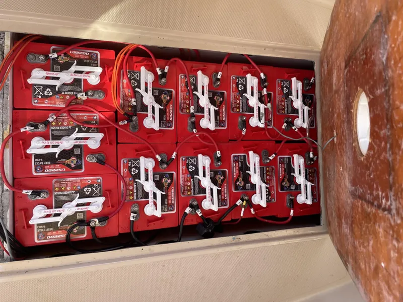 Slide: The Image of Battery compartment of a 2008 Duffy Cuddy 22 boat with multiple red batteries. - 5