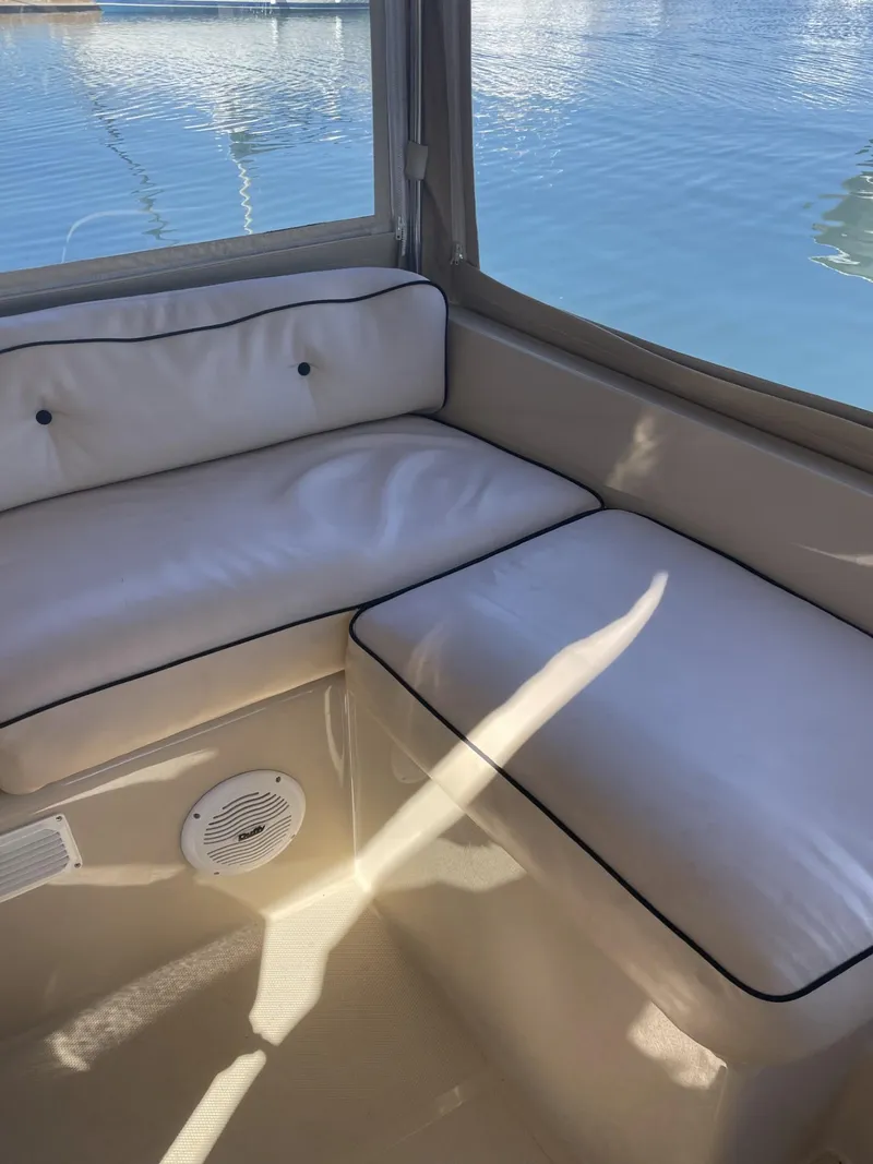 Slide: The Image of Interior seating of a 2008 Duffy Cuddy 22 boat with white cushions. - 6