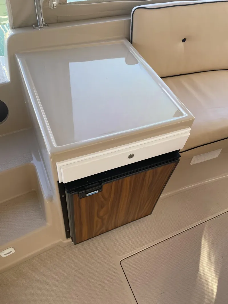 Slide: The Image of Interior of 2008 Duffy Cuddy 22 boat with compact fridge and seating area. - 7