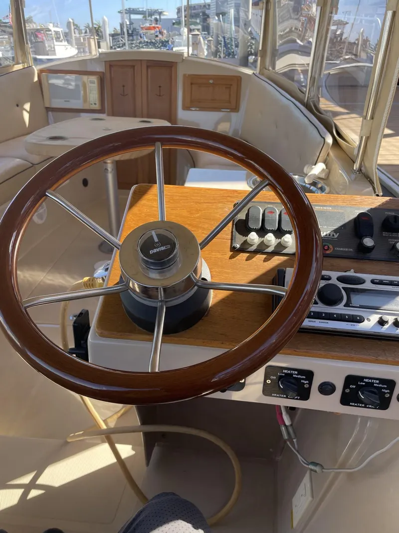 Slide: The Image of Steering wheel and controls of a 2008 Duffy Cuddy 22 boat interior. - 9
