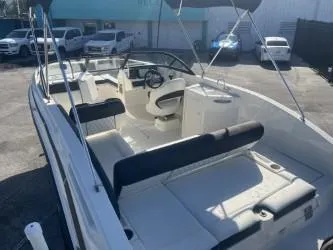 Slide: The Image of 2021 Bayliner DX 2200 boat with spacious seating and modern design. - 6