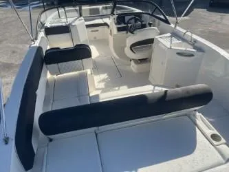 Slide: The Image of 2021 Bayliner DX 2200 boat interior with seating and steering wheel, viewed from above. - 7