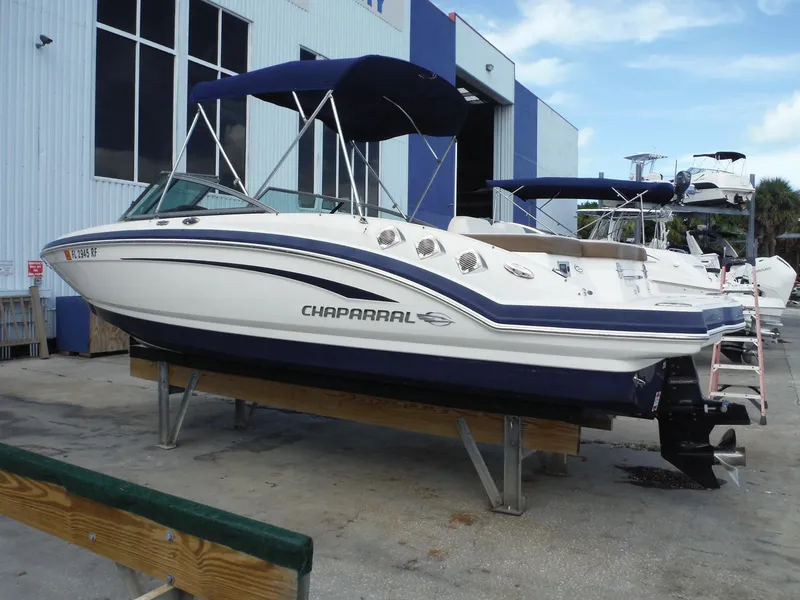The Image of 2015 Chaparral 226 SSi boat on display at a marina, featuring a sleek design. - 0