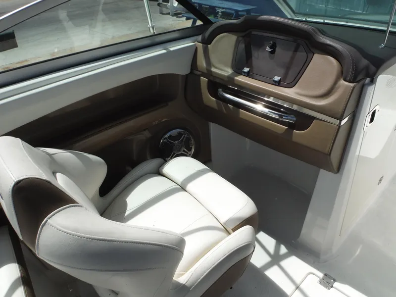Slide: The Image of 2015 Chaparral 226 SSi boat interior with white and brown seating. - 14