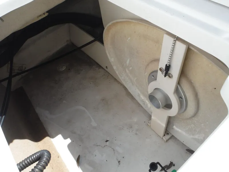 Slide: The Image of 2015 Chaparral 226 SSi boat interior showing storage compartment and mechanical components. - 26