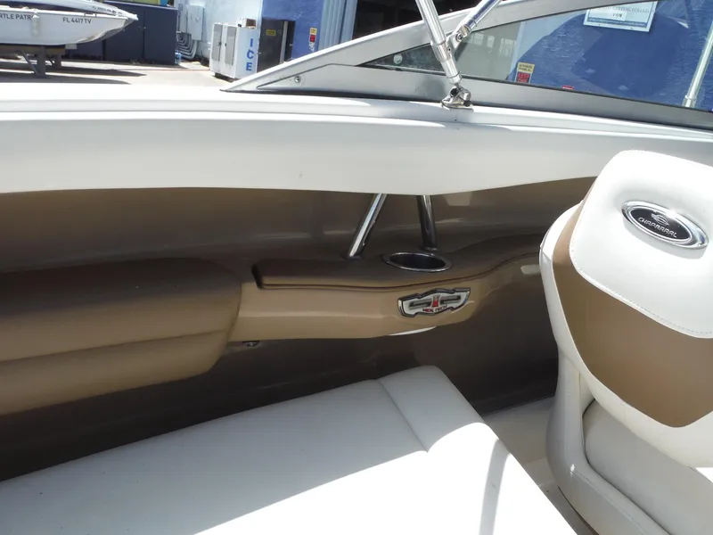 Slide: The Image of 2015 Chaparral 226 SSi boat interior with beige seating and cup holder. - 27