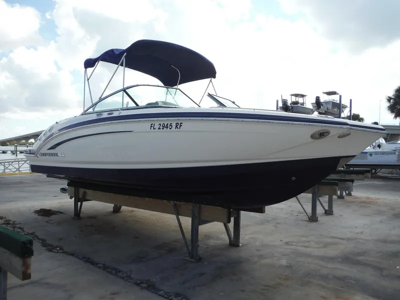 Slide: The Image of 2015 Chaparral 226 SSi boat on dry dock with blue canopy. - 3