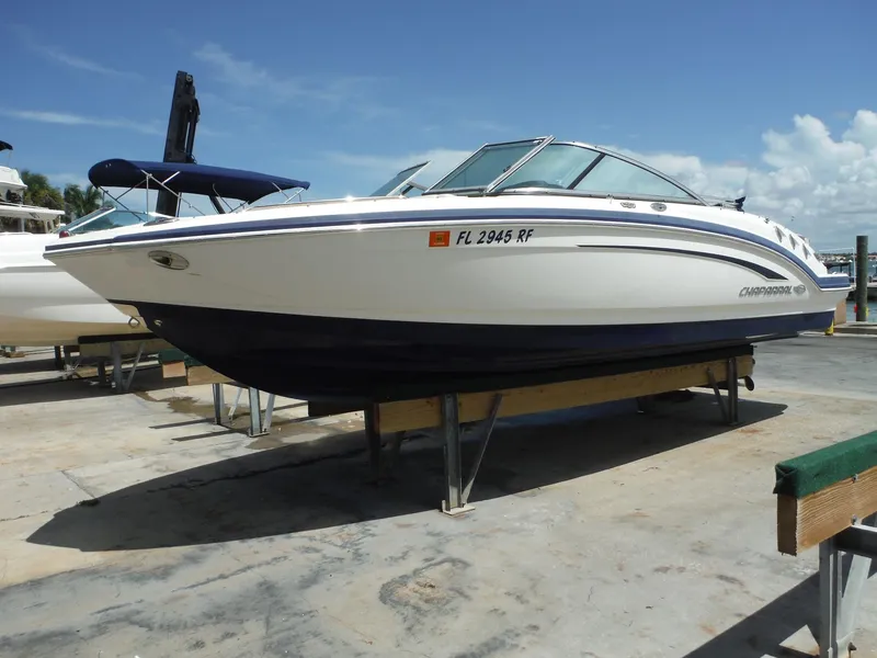 Slide: The Image of 2015 Chaparral 226 SSi boat on display at a marina under clear blue skies. - 33