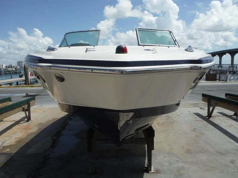 Slide: The Image of 2015 Chaparral 226 SSi boat on dock, clear sky, waterfront view. - 34