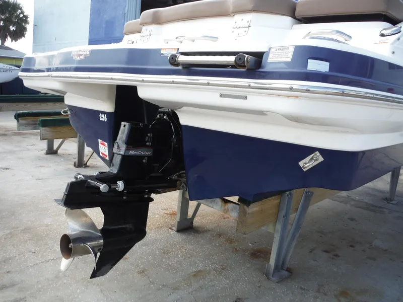 Slide: The Image of 2015 Chaparral 226 SSi boat stern with MerCruiser engine, docked on a stand. - 8