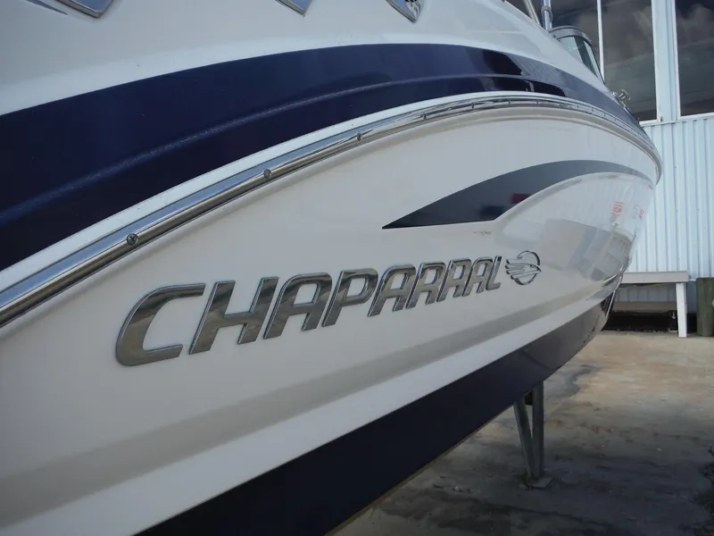 Slide: The Image of 2015 Chaparral 226 SSi boat with sleek design and logo on the side. - 9