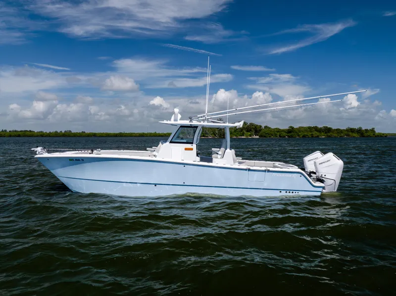 Slide: The Image of 2024 Freeman 35 boat on water under blue sky with clouds. - 1