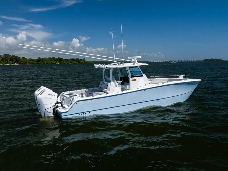 Slide: The Image of 2024 Freeman 35 boat on open water, featuring twin Mercury engines under a clear blue sky. - 11