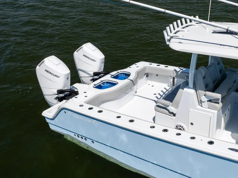 Slide: The Image of 2024 Freeman 35 boat with dual Mercury engines on water. - 12