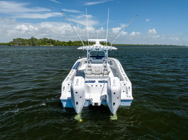 Slide: The Image of 2024 Freeman 35 boat on water, rear view with dual engines, clear sky. - 13