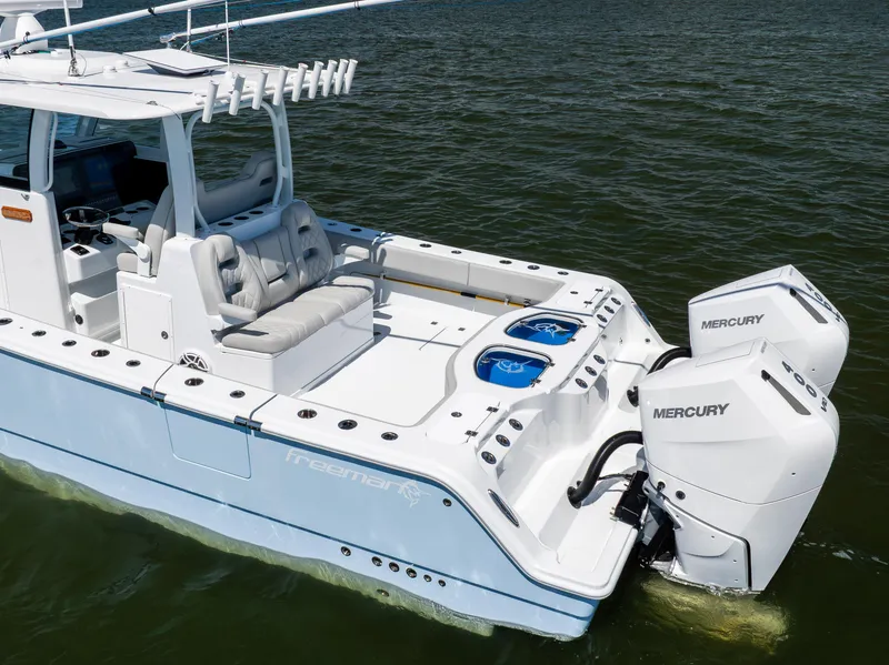 Slide: The Image of 2024 Freeman 35 boat with dual Mercury engines on calm water. - 14