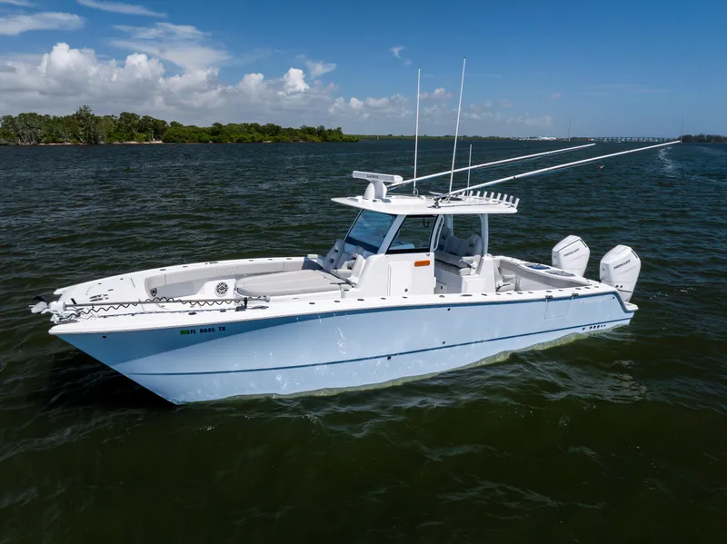 Slide: The Image of 2024 Freeman 35 boat on water, clear sky, dual engines, sleek design. - 2