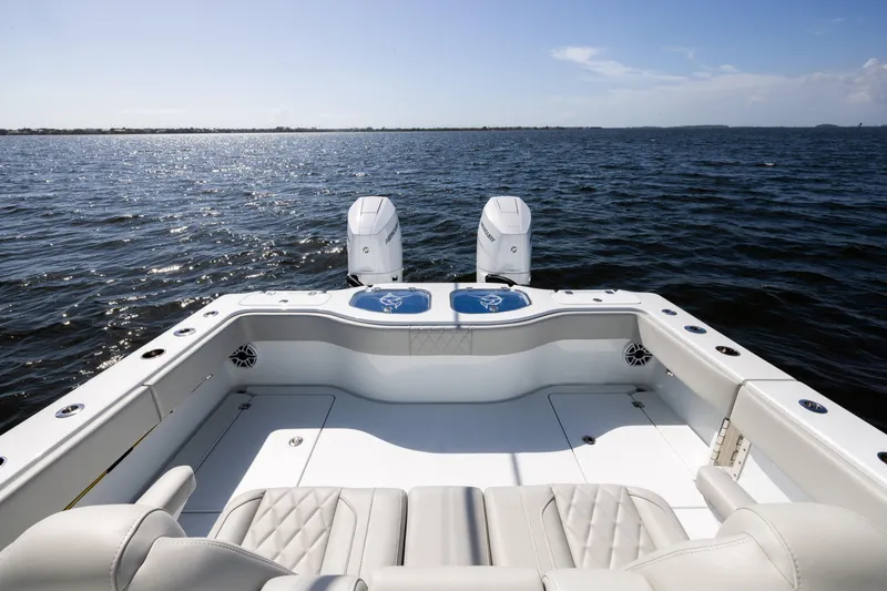 Slide: The Image of 2024 Freeman 35 boat with dual engines on open water, featuring spacious seating. - 26