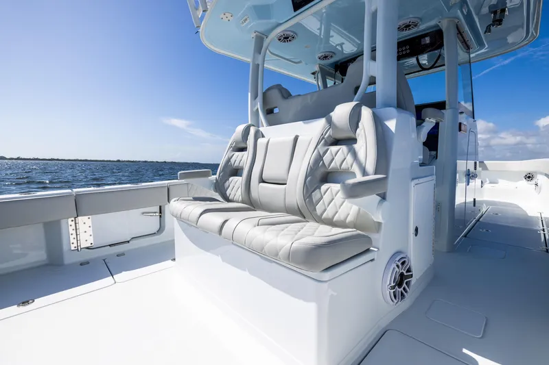 Slide: The Image of 2024 Freeman 35 boat interior with luxurious seating, ocean view, and clear blue sky. - 37