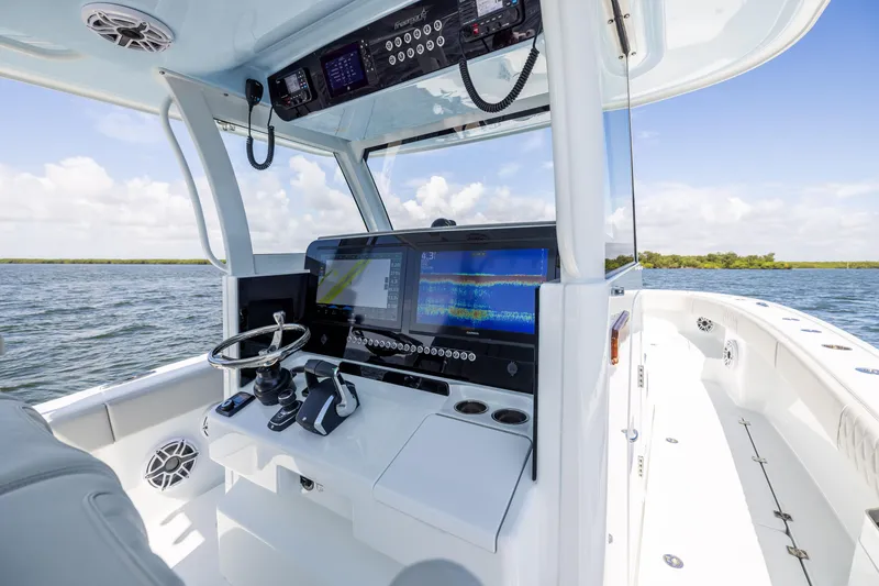 Slide: The Image of 2024 Freeman 35 boat cockpit with advanced navigation systems on open water. - 45