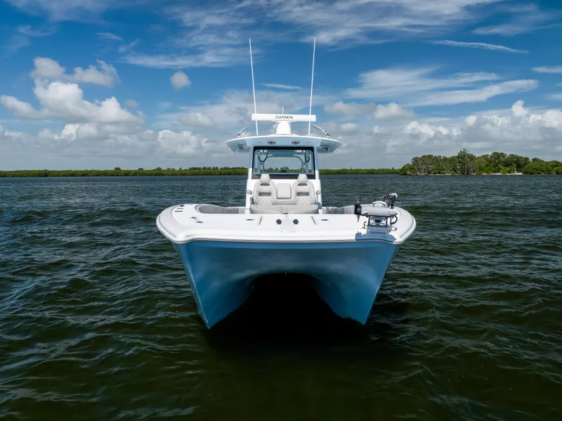 Slide: The Image of 2024 Freeman 35 boat on open water under a clear blue sky. - 5