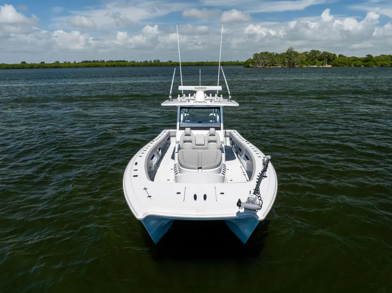 Slide: The Image of 2024 Freeman 35 boat on water, clear sky, lush shoreline in background. - 6