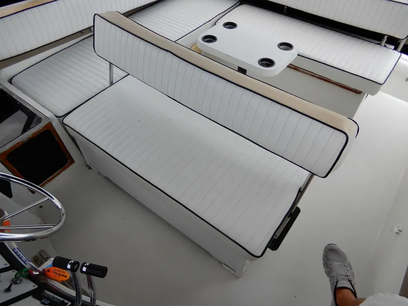 Slide: The Image of 1987 Carver 28 Mariner Voyager interior with white seating and table. - 15