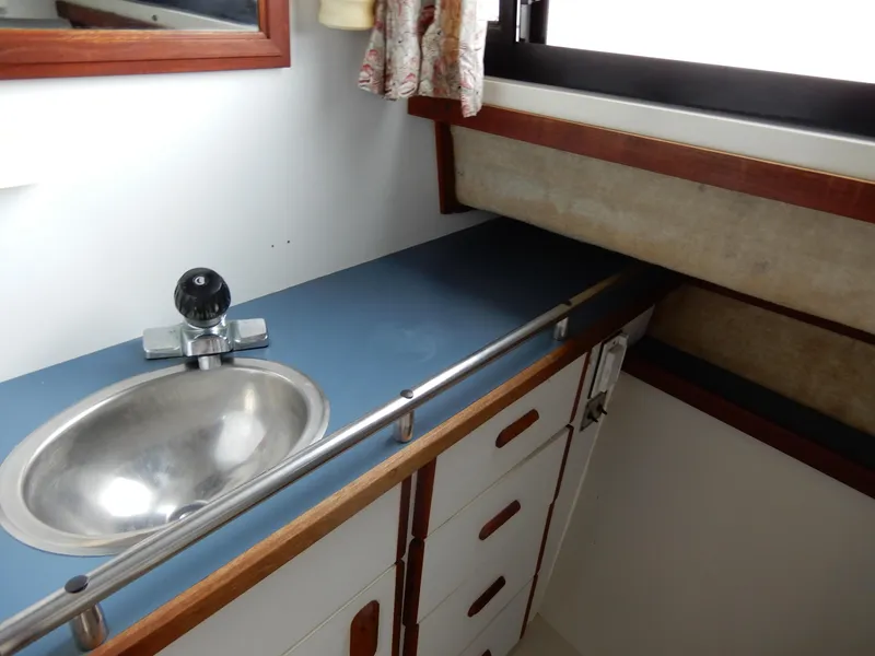Slide: The Image of 1987 Carver 28 Mariner Voyager bathroom with sink, faucet, and storage cabinets. - 39