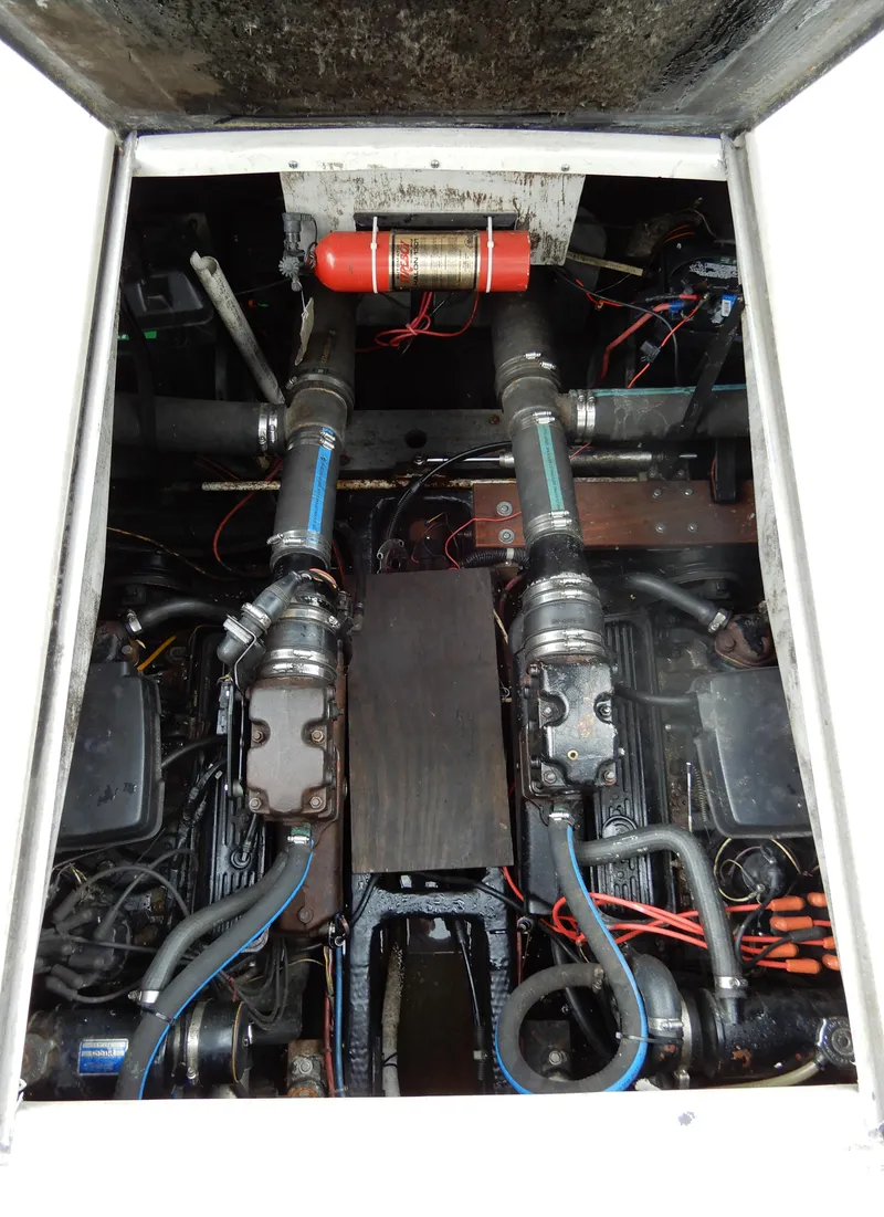 Slide: The Image of Engine compartment of a 1987 Carver 28 Mariner/Voyager with visible components and wiring. - 47