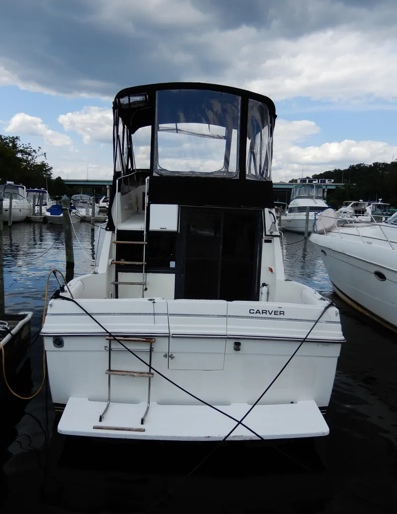 Slide: The Image of 1987 Carver 28 Mariner Voyager docked at marina under cloudy sky. - 6