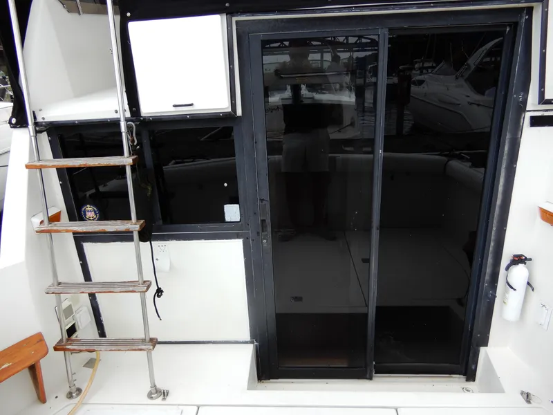 Slide: The Image of 1987 Carver 28 Mariner Voyager boat with sliding glass door and ladder. - 7