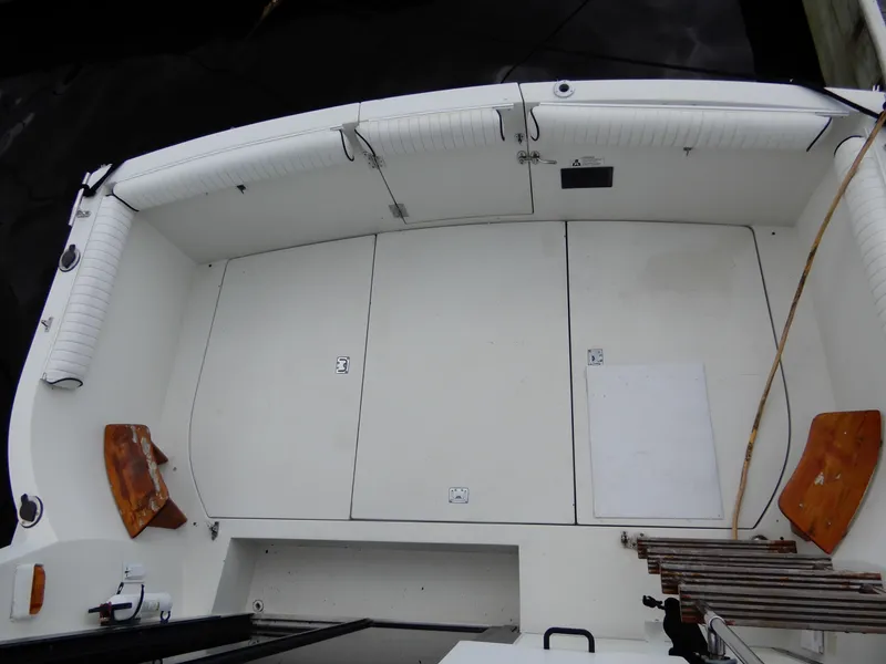 Slide: The Image of 1987 Carver 28 Mariner Voyager boat deck with white seating and wooden accents. - 10